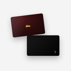 Carte d'affaires Majellan : carte metallique bordeaux au logo dore et carte noire avec symbole sans contact